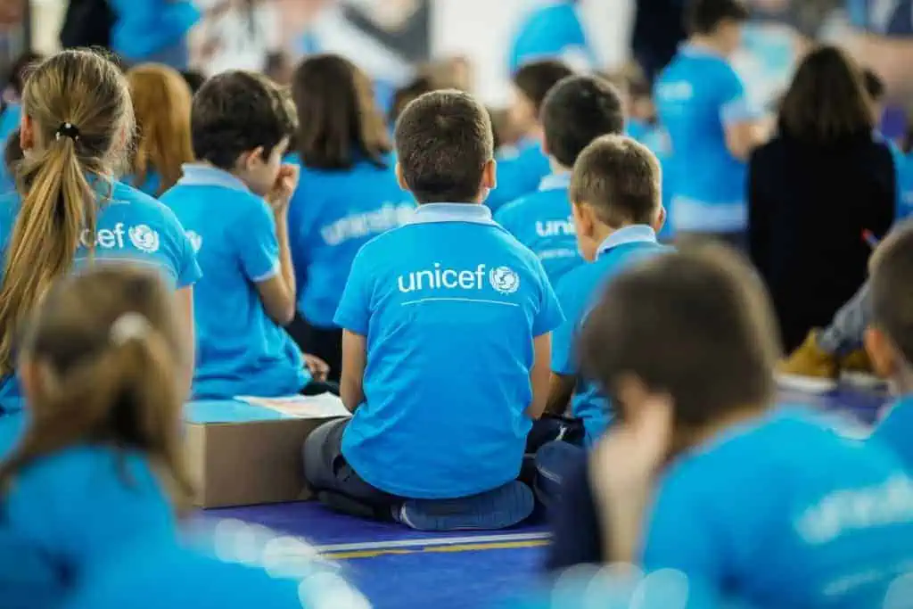 Bucharest, Romania - November 19, 2019: Children wearing Unicef shirts take part at an event. Unicef logo.